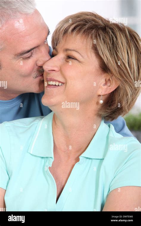 Mature couple kissing tenderly Stock Photo - Alamy