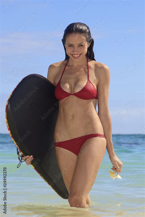 young woman at the beach in hawaii with her boogie board Stock Photo ...