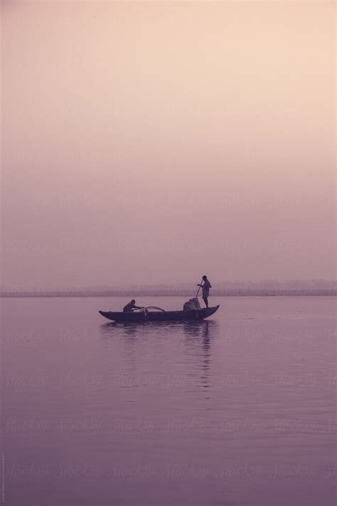 "Indian Fishermen On A Boat On The Ganges At Sunset" by Stocksy