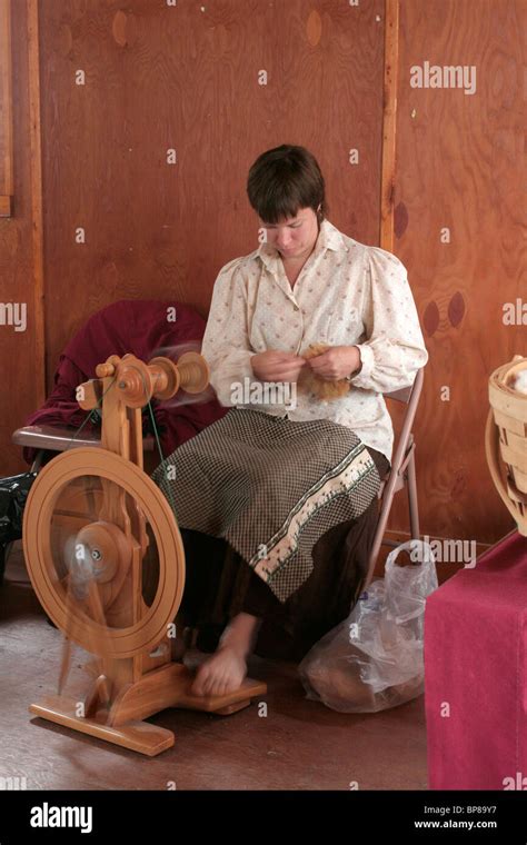 Spinning wool with a spinning wheel Stock Photo - Alamy