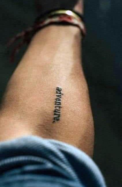 mens  forearm minimalist word adventure tattoo idea
