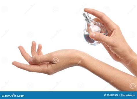 Young Woman Spraying Perfume Onto Skin Against White Background Stock ...
