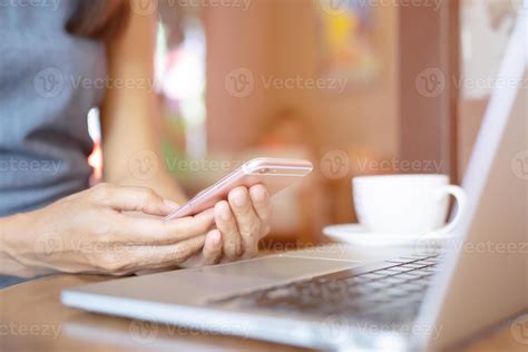 close up hand people person woman at computer laptop using mobile phone