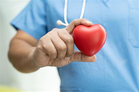 asian senior woman patient holding red heart  stock photo