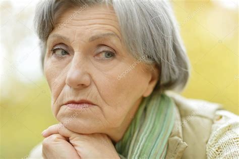 Sad old woman in autumn Stock Photo by ©aletia 62955283