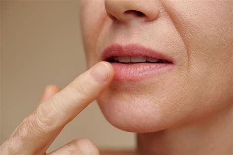 premium photo woman applying hydrating lip teatment