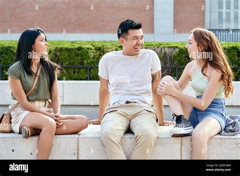 Three happy diverse friends sitting hi-res stock photography and images ...