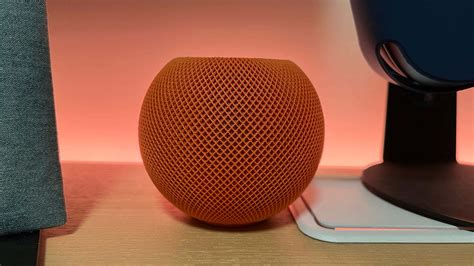 Download Apple Homepod On Wooden Table Wallpaper | Wallpapers.com