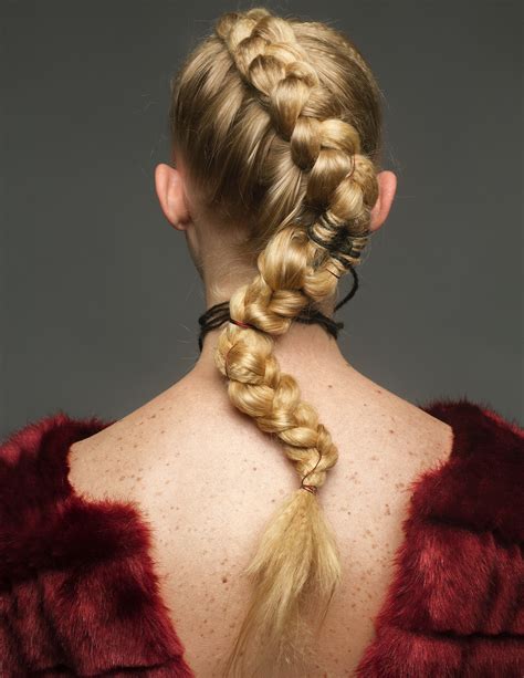 person braiding  womans hair  stock photo