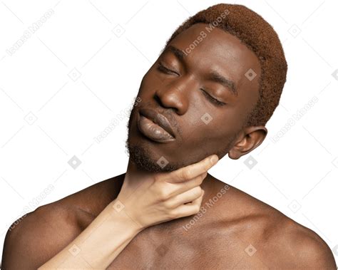 White hand holding neck of a young black man Photo