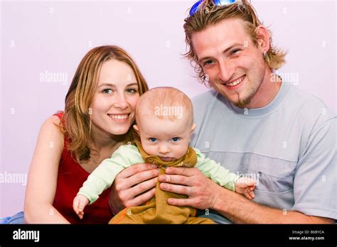 Happy young family mother 25 years father 25 years and son 7 months ...