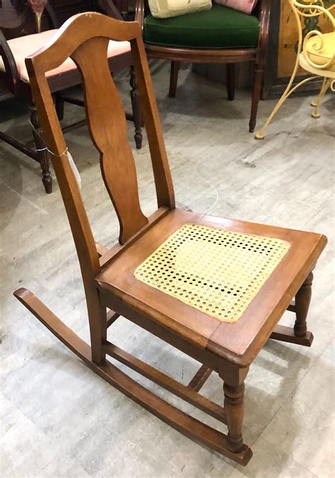 Lot - Antique sewing rocker with caned seat.