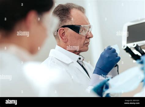 scientists putting   protective mask   medical laboratory stock