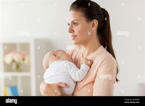 mother holding sleeping baby Stock Photo - Alamy