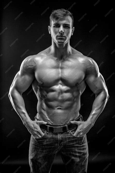 Premium Photo | Muscular bodybuilder guy doing posing over black background