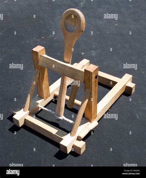 Wooden catapult toy on dark background Stock Photo - Alamy