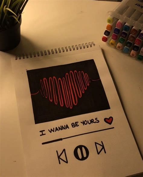 a notebook with the words i wanna be yours on it next to a potted plant