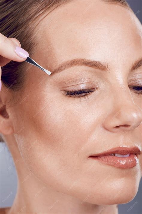 Premium Photo | Eyebrow tweezers face beauty and woman in studio for