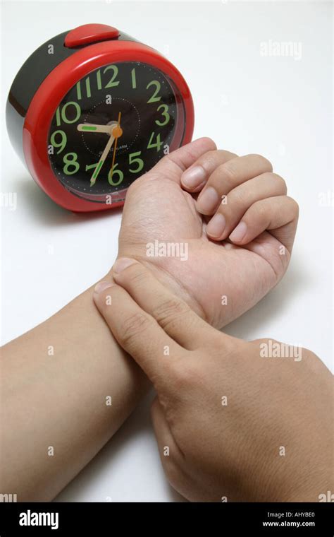 fingers taking pulse to measure heartbeat rate with clock Healthcare ...