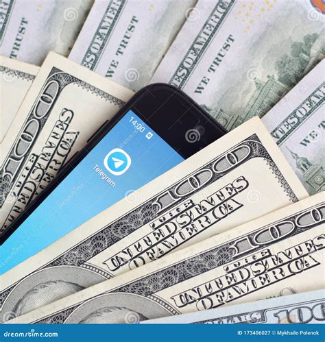Smartphone Screen with Telegram App and Lot of Hundred Dollar Bills