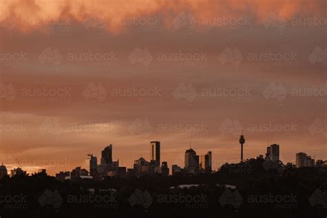 Image of The Sydney city skyline silhouetted at sunset - Austockphoto