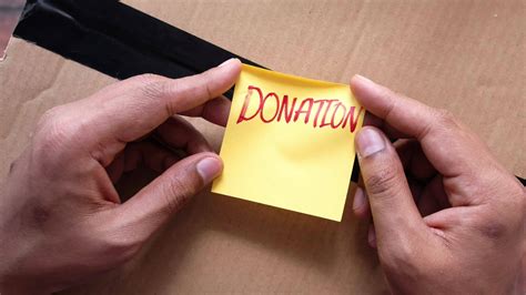 holding a paper with hand written donation text top view 23162534 Stock ...