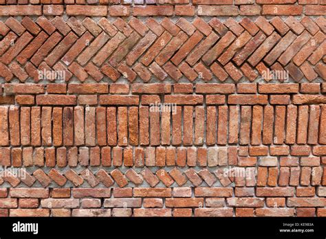 Old red bricks wall with an original design Stock Photo - Alamy