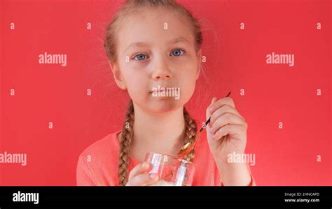 Child eating yogurt jelly pink background. Dairy product diet ...