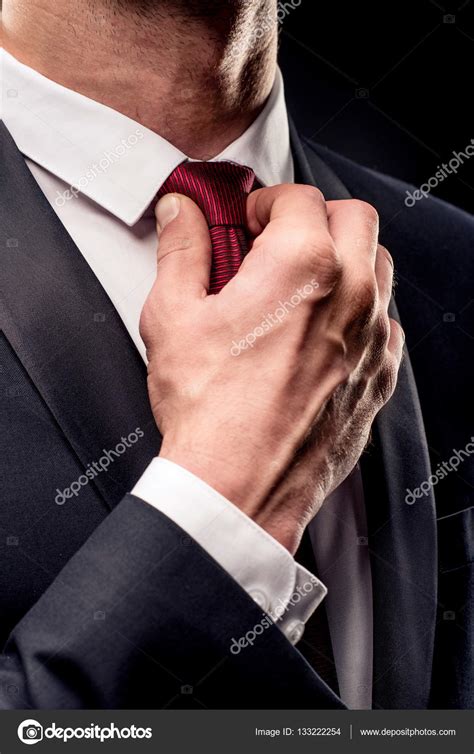 Businessman adjusting tie Stock Photo by ©DmitryPoch 133222254
