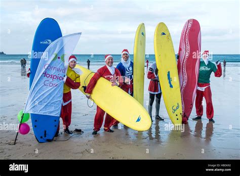 Surfing Santas at the fund-raising Santa Surfing competition on chilly Fistral Beach in Newquay ...