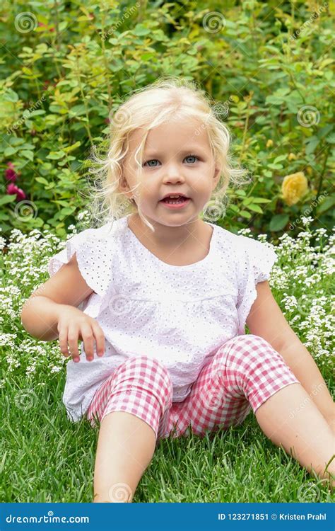 Cute Little Girl Sitting in the Grass in the Garden Stock Image - Image of child, garden: 123271851