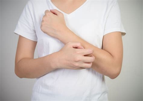 premium photo woman scratching  arm