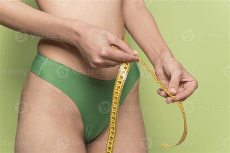 girl measures her volumes with a measuring tape. healthy and beautiful body. Female body, slim ...