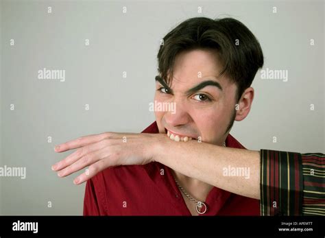 young man biting  womans arm released stock photo alamy