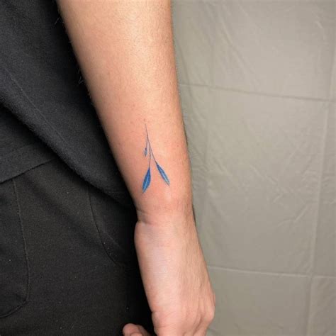 Sprig tattoo on the wrist.