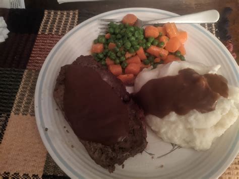 Classic Meatloaf dinner, with mashed potatoes, fresh peas and carrots
