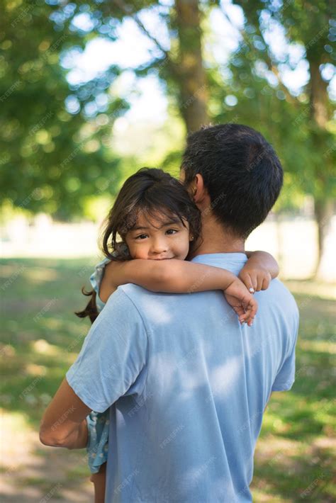 Premium Photo | Asian man holding little girl on his hands in park