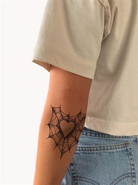 spider web on elbow tattoo meaning 8