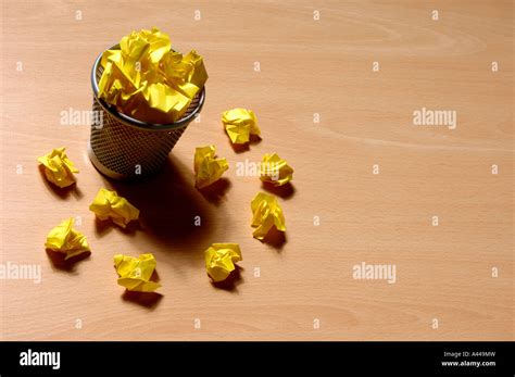 Bin and yellow waste paper Stock Photo - Alamy