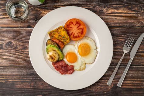 rustic breakfast plate  fried eggs grilled vegetables  turkey