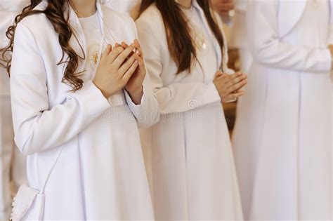 child praying  folded hands   holy communion ceremony