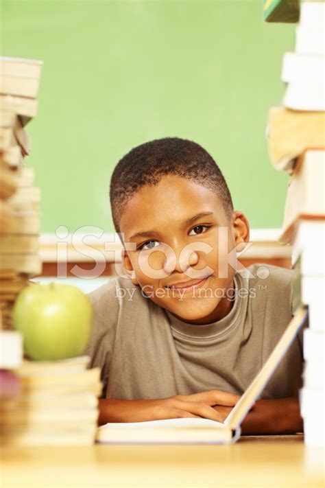 Portrait Of An African American Boy With Book Stack Reading Stock Photo ...