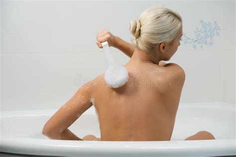 Rear View Photo of Beautiful Young Woman with Back Washing in Shower