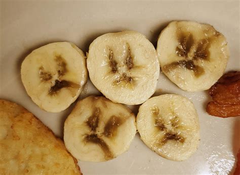 My sliced banana has brown spots that look like a frowney face : r