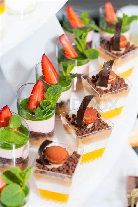 mini canapes in plastic cups decorated with edible flowers | Stock ...