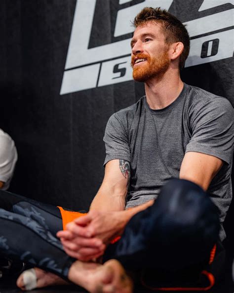 Download Cory Sandhagen Sitting On The Floor Wallpaper | Wallpapers.com