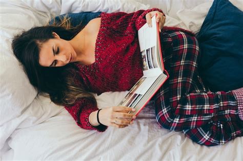 Free Photo | Charming woman reading while lying in bed