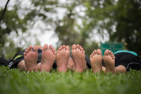 Close-up of family feet together on a green field 1924413 Stock Photo