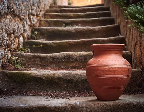 A Rustic Terracotta Amphora Rests on Weathered Stone Steps Stock ...