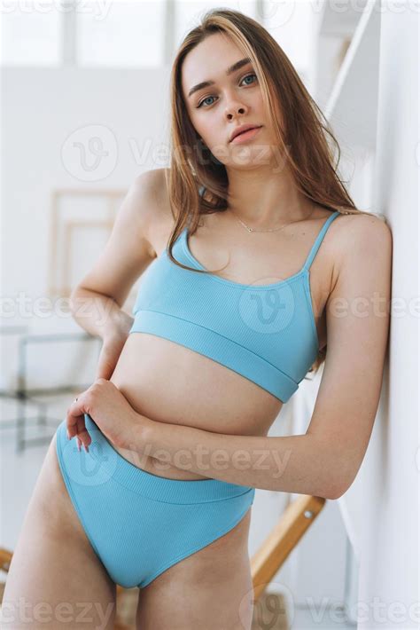 Beautiful young woman beauty fashion model with long hair in light blue ...
